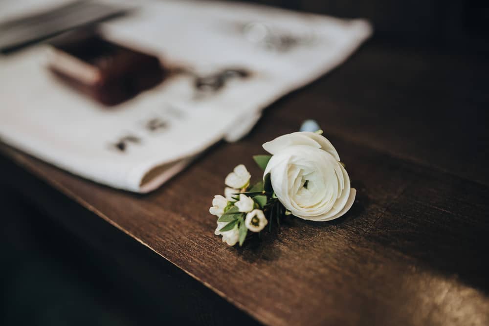 Wedding boutonniere on a wooden table