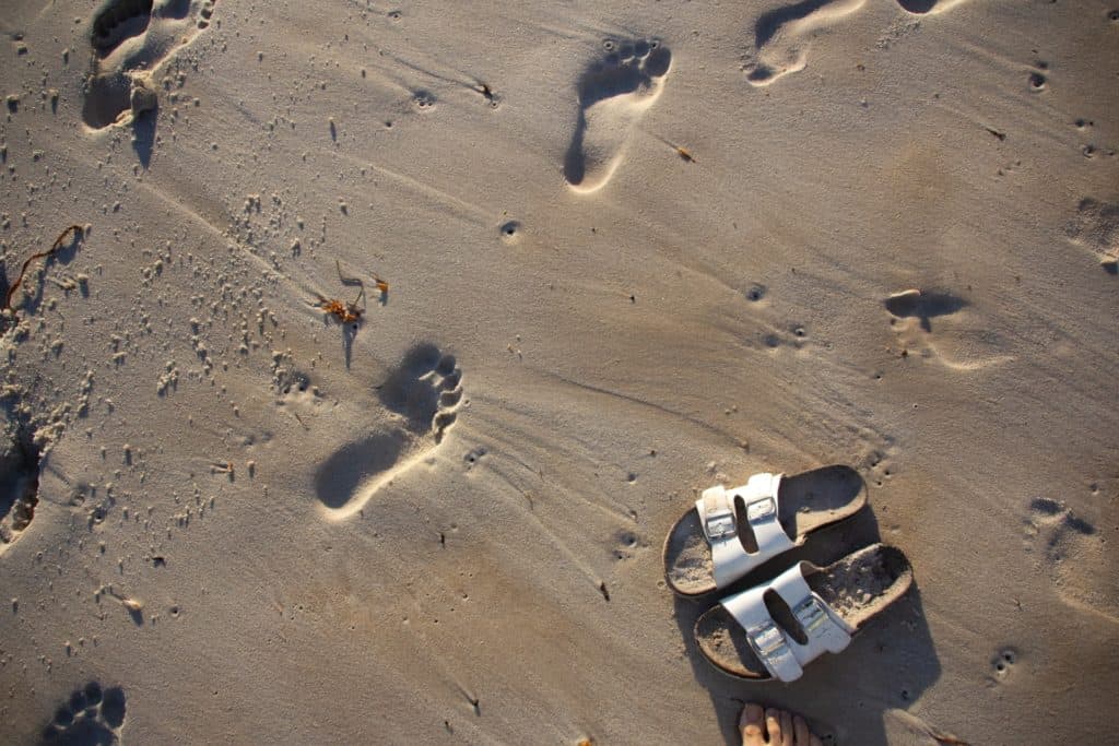 Sandals and footprints in Squeaky Beach